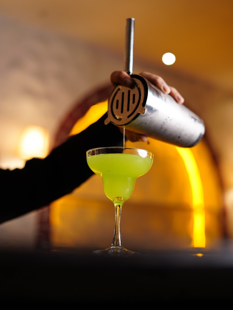 A cocktail poured into a stemmed glass