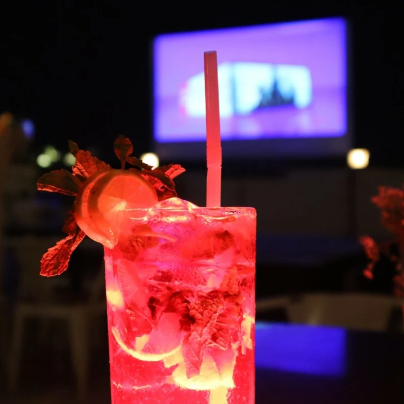 A red highball with lime, mint, and ice